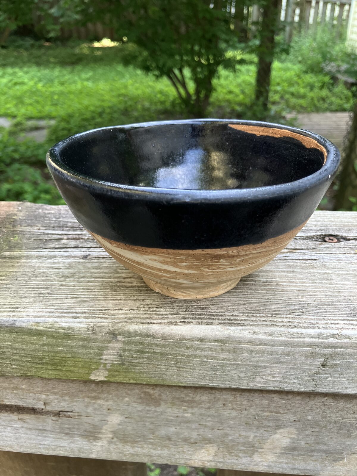 Matte black ceramic bowl with natural rim