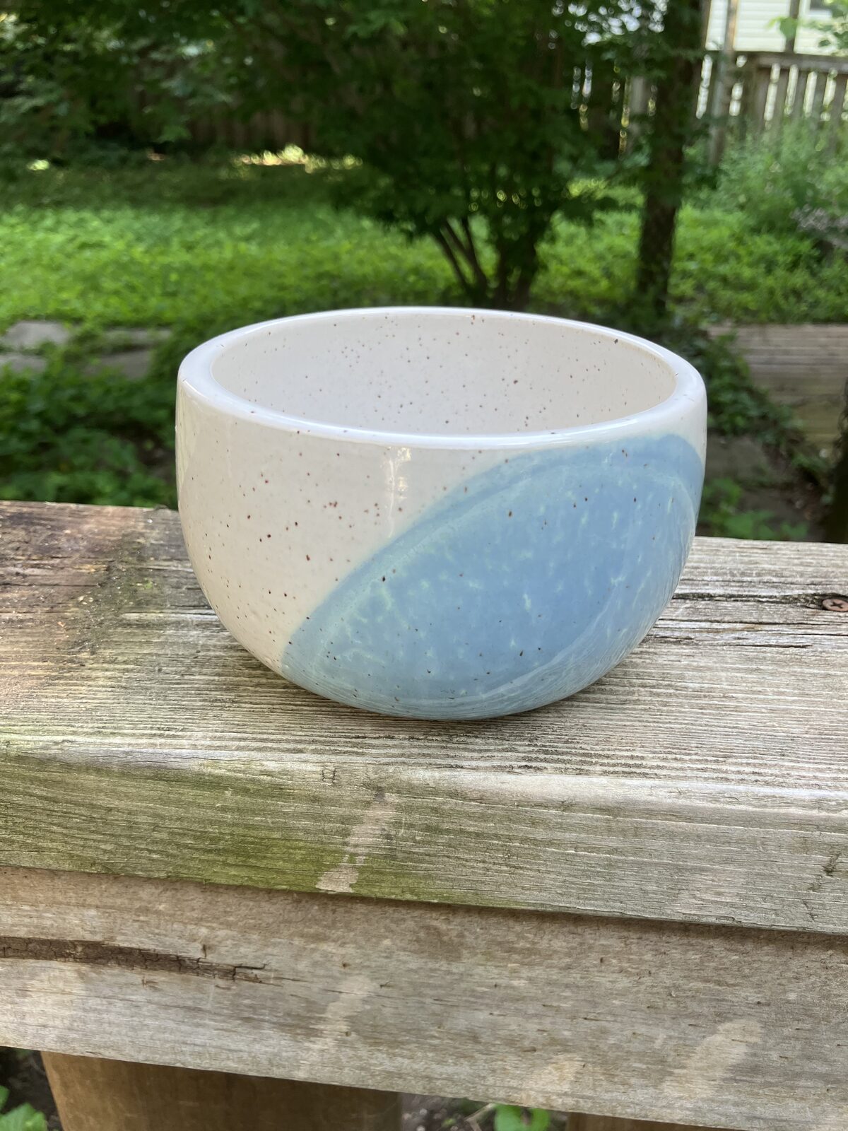 White ceramic bowl with pale blue glaze accents
