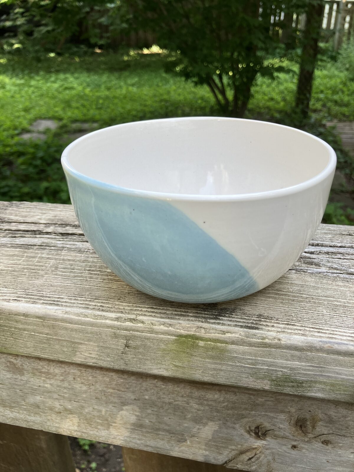 White ceramic bowl dipped in seafoam glaze