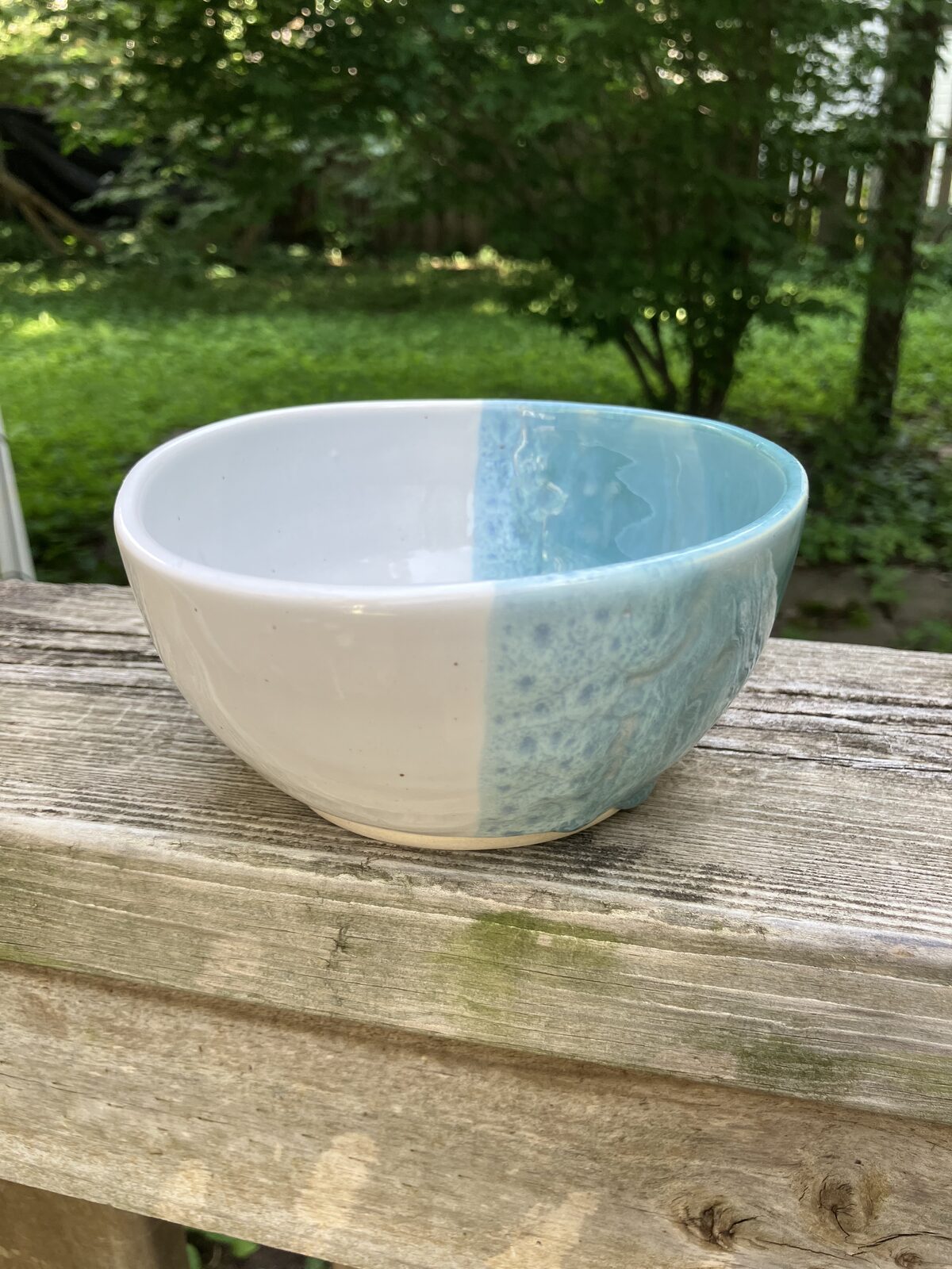 White ceramic bowl dipped in sky blue glaze