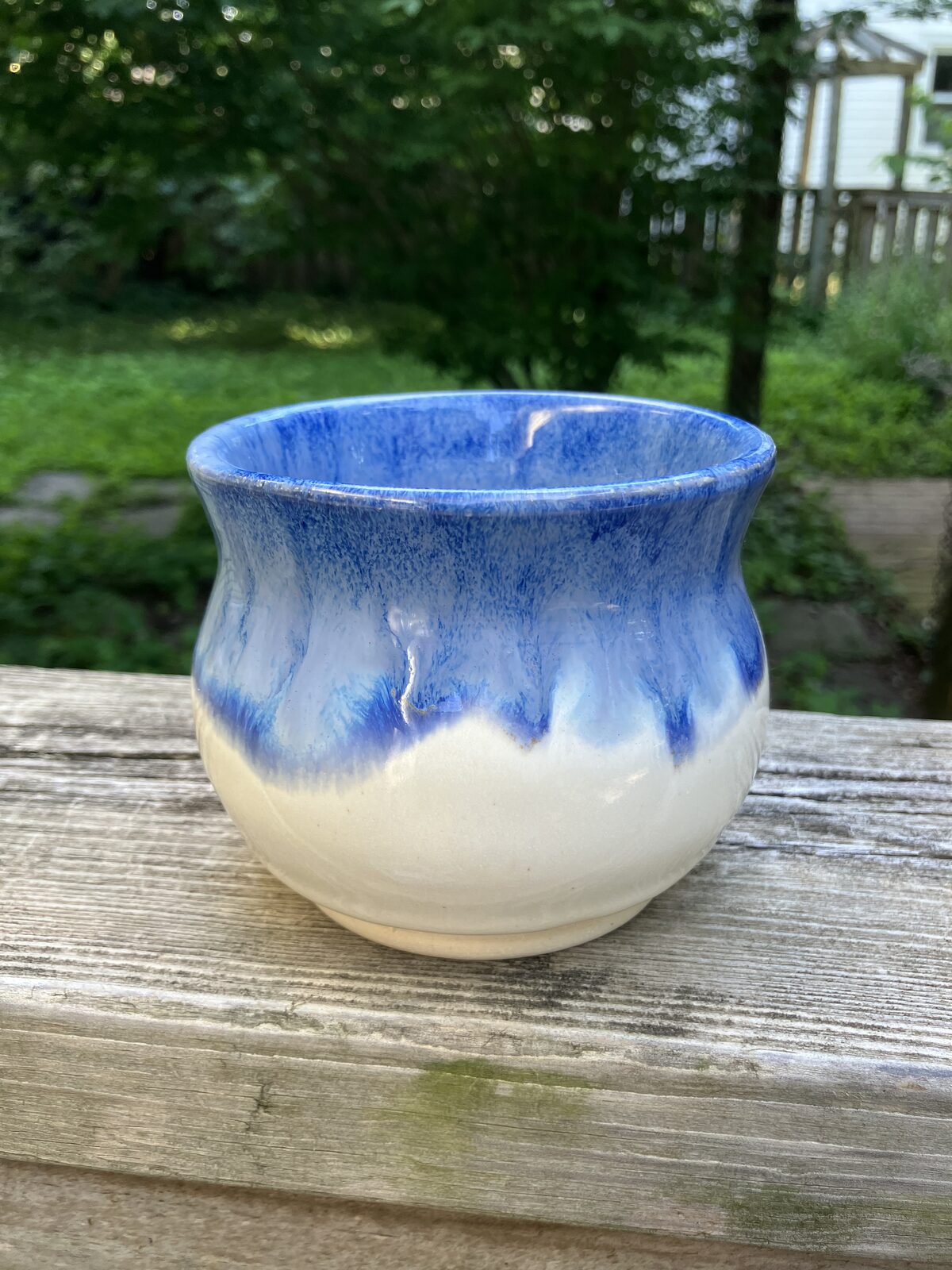 White ceramic cup with blue drip glaze