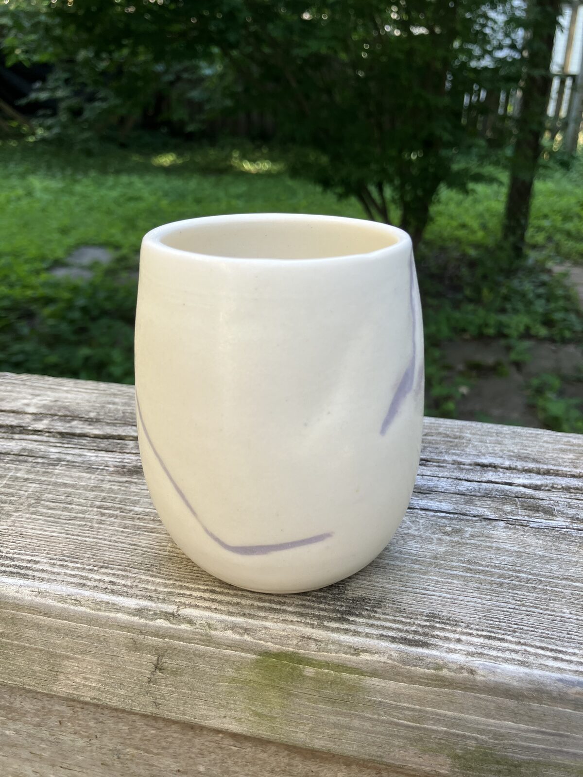 Cream ceramic tumbler with subtle marbling