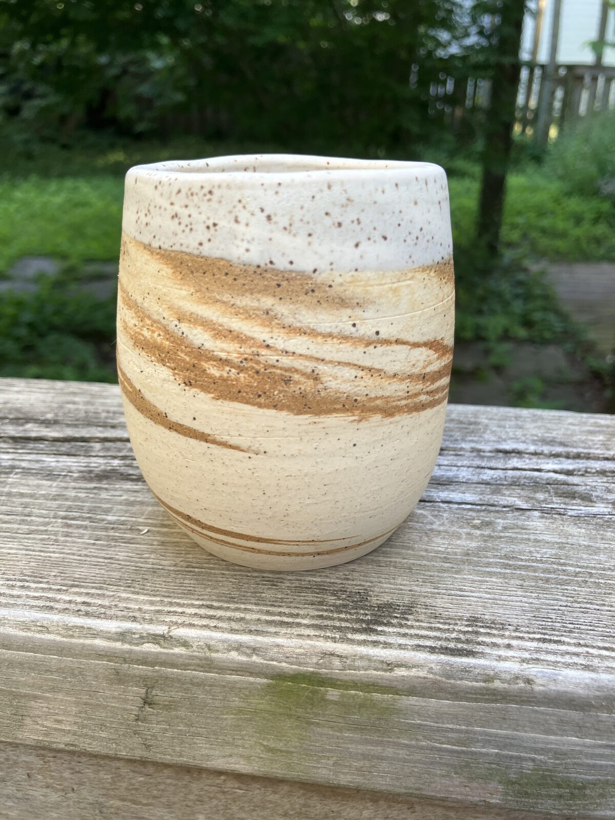 Sandstone-colored ceramic tumbler with white rim