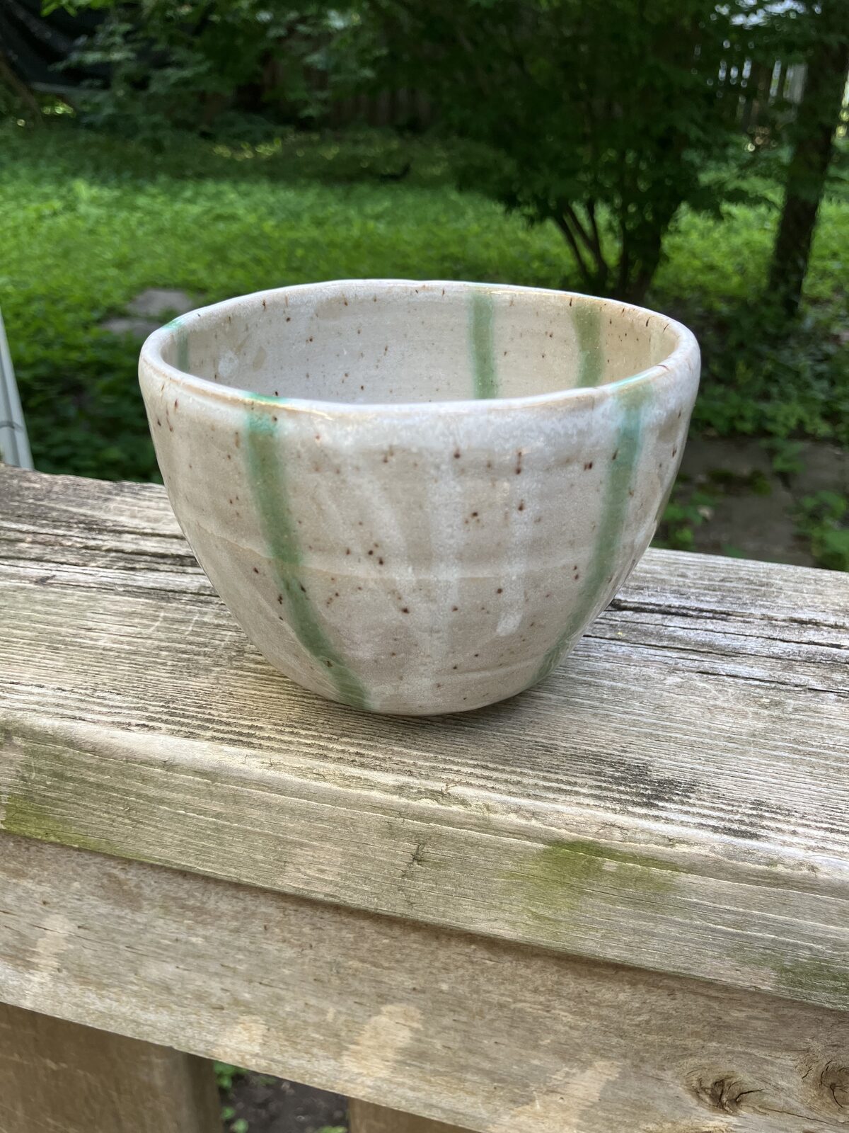 White ceramic bowl with sage green swirl
