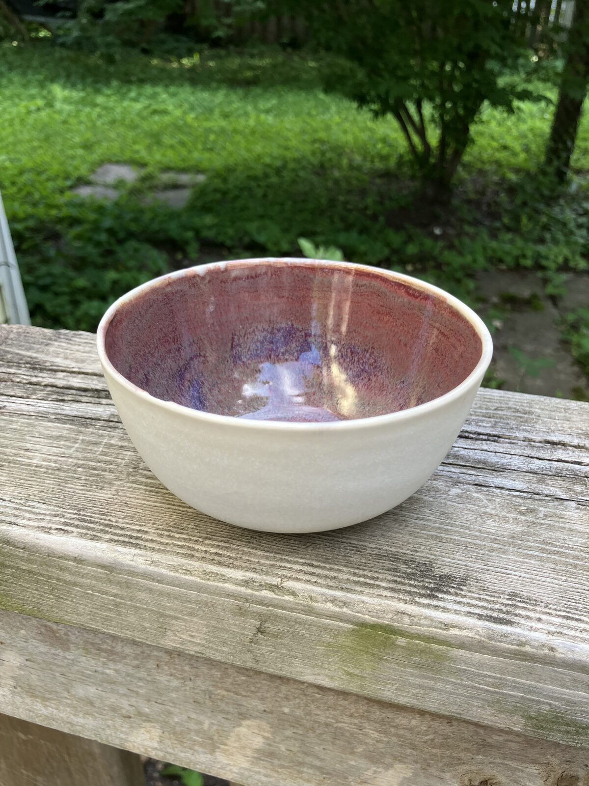 White ceramic bowl with deep plum interior glaze