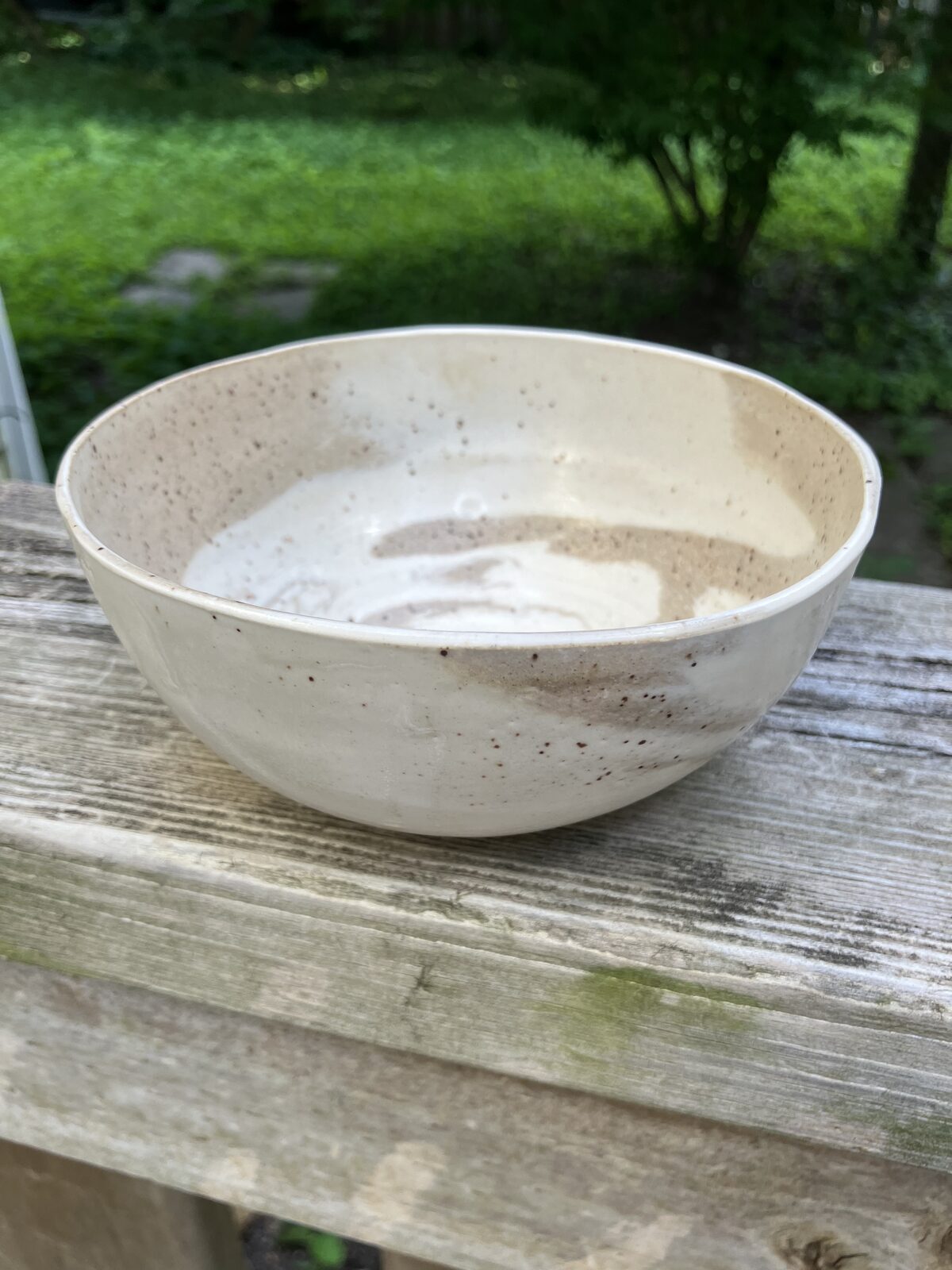 Cream ceramic bowl with speckled tan glaze