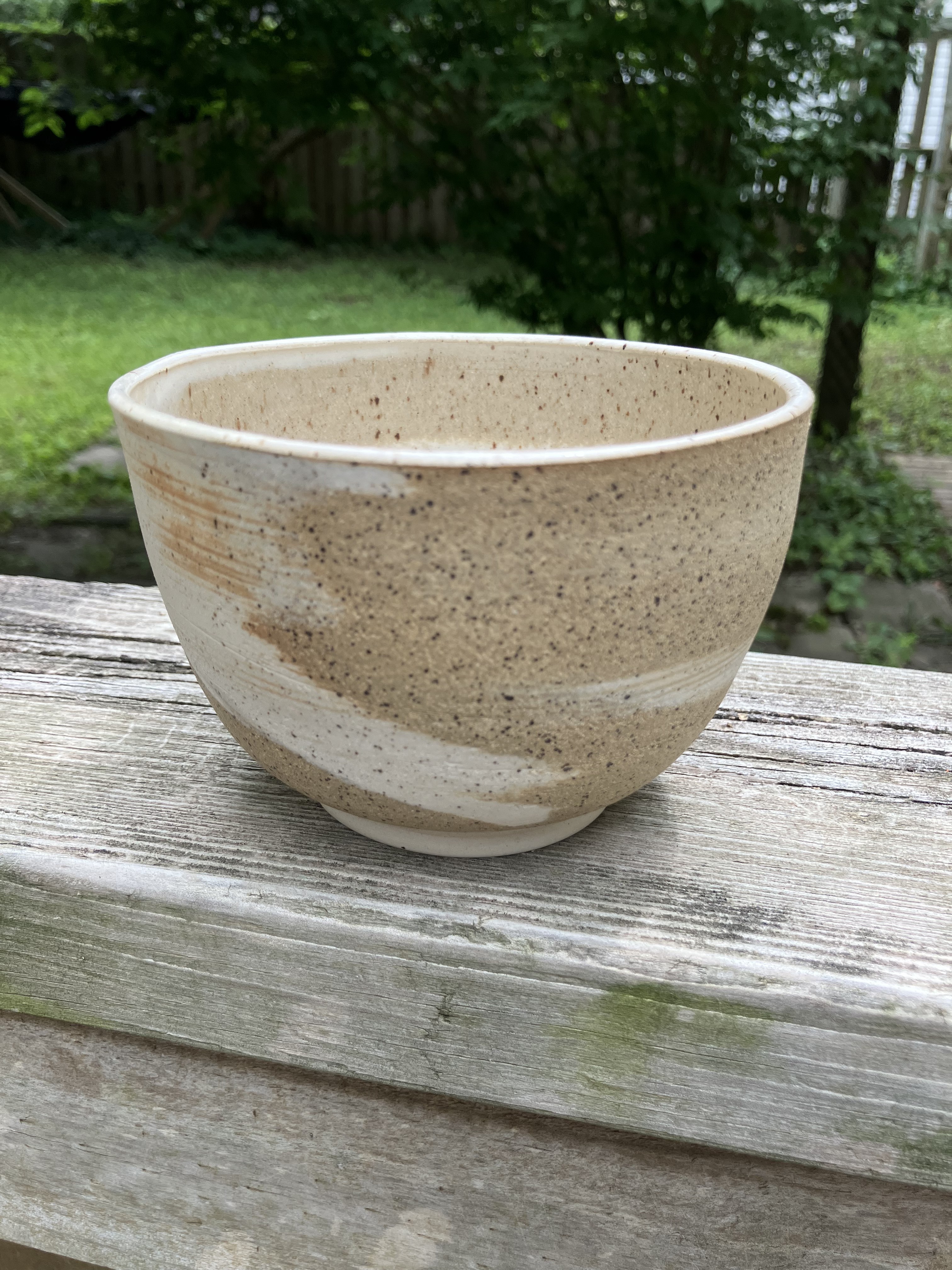 Cream ceramic bowl with speckled tan glaze